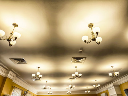 Decorative ceiling lights cast a warm glow across the spacious interior, highlighting the warm...