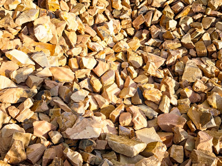 The close-up view reveals an array of crushed stones showing earthy tones and textures, ideal for...