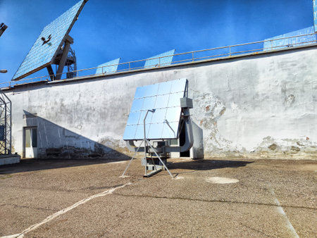 Solar panels are positioned on a rooftop and ground, harnessing sunlight at an industrial site...