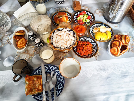 Diverse breakfast selection arranged on a table with pastries, fruits, and drinks, showcasing local food culture and hospitality.の写真素材