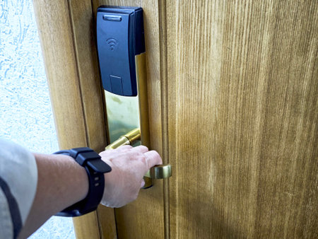 Hand grasping brass doorknob on wooden door, wristwatch visible, close-up POV capturing unlocking...