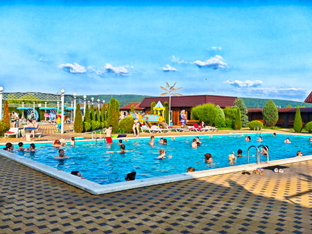 Maikop, Russia - June 04, 2025: Families and friends enjoy activities by the vibrant pool at Water Riviera in Maikop under a clear blue sky.のeditorial素材