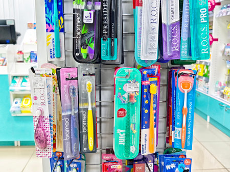 Kirov, Russia - August 30, 2025: A selection of colorful toothbrushes is arranged neatly on display in a pharmacy, showing different options for oral hygiene.のeditorial素材