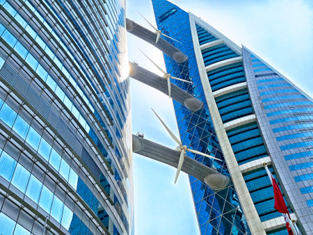 Sleek modern buildings in Manama, Bahrain feature decorative wind turbines, highlighting a blend of technology and urban design.の写真素材