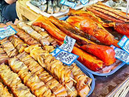 Kirov, Russia - July 17, 2025: Colorful selection of grilled fish and meats displayed at a bustling street market, inviting visitors to taste local flavors.のeditorial素材