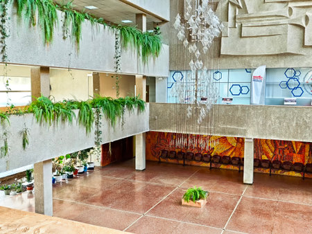 Kirov, Russia - September 16, 2025: This indoor space combines modern architecture with plants, art, and cozy seating for a welcoming atmosphere.のeditorial素材