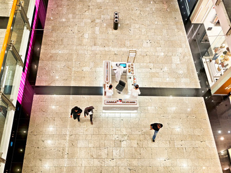 Manama, Bahrain - September 28, 2025: Shoppers walk around the spacious mall in Manama, Bahrain, exploring stalls and enjoying the lively atmosphere in the evening.のeditorial素材
