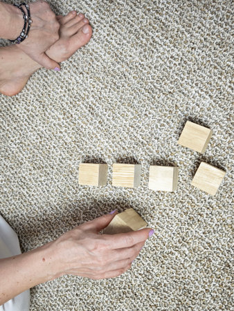 Wooden blocks being arranged by hands. Concept of workflow, planning process, organization and step...