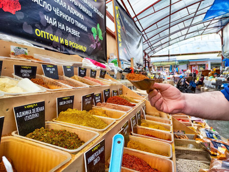 Kirov, Russia - June 13, 2024: in a busy market, shoppers browse and pick different spices from shelves filled with colorful containers, creating a vibrant shopping sceneのeditorial素材