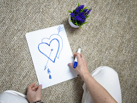 Hand drawing heart with tears. Concept of emotional pain process, grief, heartbreak and healing awareness.の写真素材