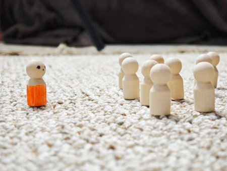 Wooden figurines represent different roles in leadership, decision-making, and social influence as...