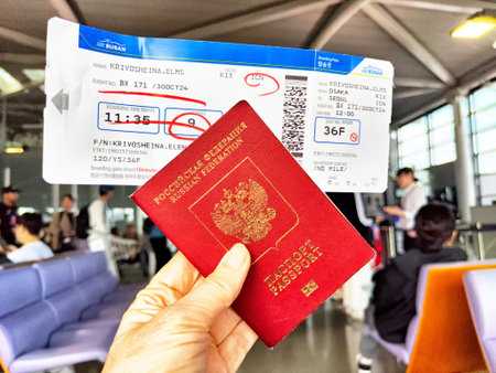 Osaka, Japan - October 30, 2024: A traveler presents a Russian passport and boarding pass at immigration control in Osaka airport during international travel.のeditorial素材