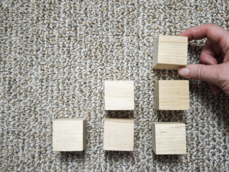 Blocks are arranged in a stepped pattern on a carpet, symbolizing growth and progress in business...