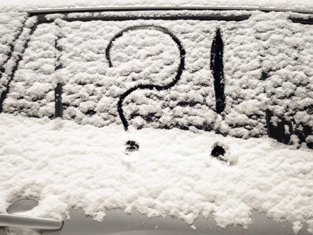 A question mark sits on a snowy windshield, representing confusion and uncertainty during winter...