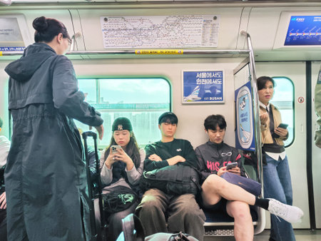 Seoul, South Korea - November 02, 2024: People are sitting and standing in a subway train in Seoul...