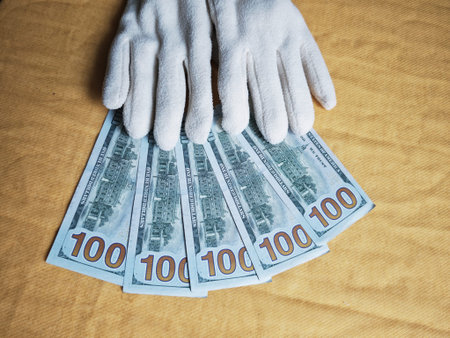 Kirov, Russia - February 20, 2026: White gloves cover euro banknotes as a way to highlight the need...
