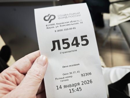 Kirov, Russia - January 14, 2026: A person holds a ticket from the Social Fund of Russia in Kirov...