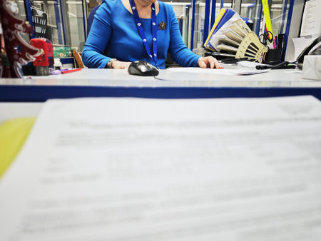 Kirov, Russia - January 14, 2026: A staff member is at the office desk submitting tax reports. Papers and office supplies are visible on the desk.のeditorial素材