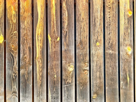 Textured wooden planks display warm hues, making it an ideal background for content or decoration...