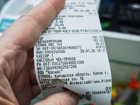 Kirov, Russia - January 29, 2026: A hand holds a receipt from a pharmacy. The receipt lists health...