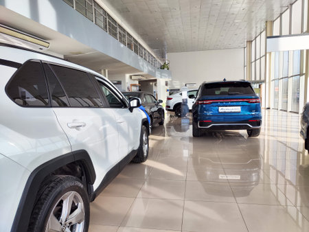 Ulan-Ude, Russia - November 04, 2024: Customers explore a modern Geely car dealership showroom with...