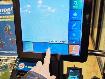 Kirov, Russia - January 29, 2026: Customer interacts with self checkout terminal to finalize payment...