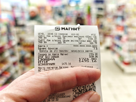 Kirov, Russia - January 15, 2026: Receipt held by a customer after completing a purchase at a...