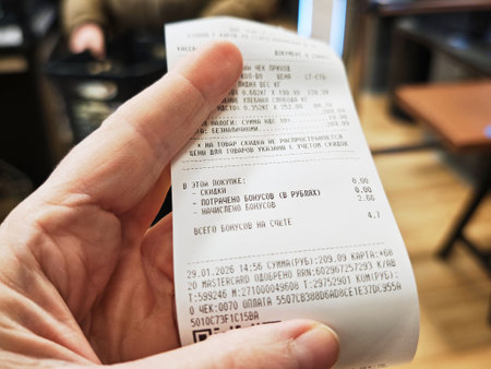 Close-up of a man's hand holding a menu in a restaurant