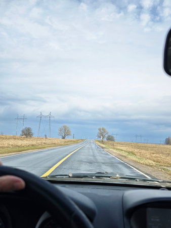 Driving a car on a rural road in the springtime.
