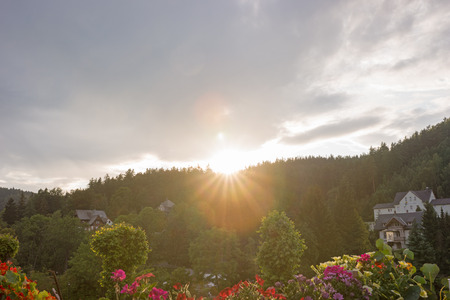 sunset mood on top of mountain with clouds and sunの写真素材