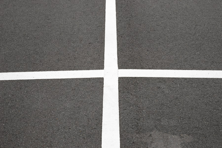 Empty parking place with white marking lines on asphalt