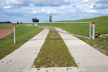 Rural road with closed barrier