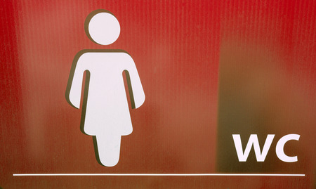 Board with symbols for women restroomの写真素材