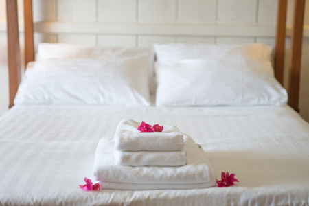 White towels with flowers in hotelの写真素材