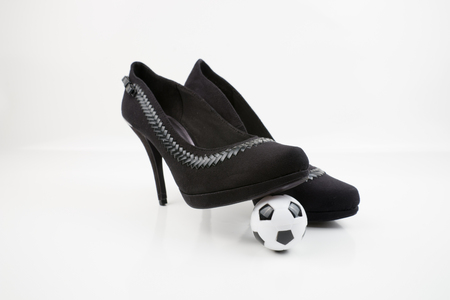 Soccer ball and high heels, isolated on white backgroundの写真素材