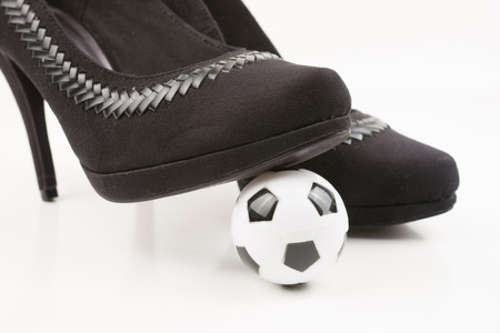 Soccer ball and high heels, isolated on white backgroundの写真素材