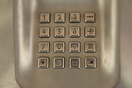 dial number button on old used public telephoneの写真素材