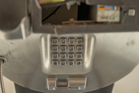 dial number button on old used public telephoneの写真素材