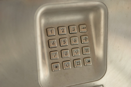 dial number button on old used public telephoneの写真素材