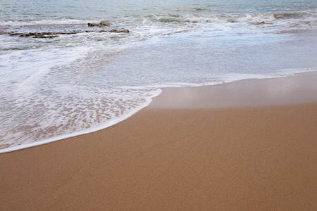 Ocean water and beach sand