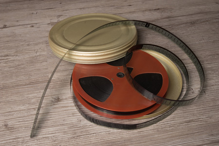 Old motion picture film reel with golden canの写真素材