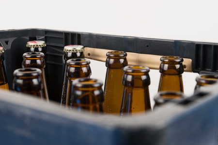 Rows of empty glass bottles in the plastic boxの写真素材