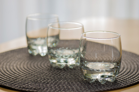 Three empty juice glasses on the tableの写真素材