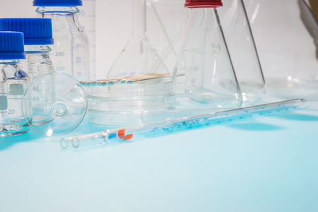 glass laboratory apparatus isolated on blue table
