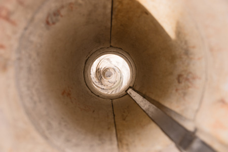 Ancient spiral stone stairs in the castle towerの写真素材