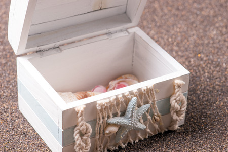 Treasure chest on dark sand - concept of holiday, beach and summer