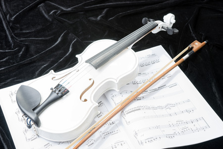Black and white violin with music notes on black background