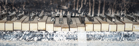 Detail of old dirty piano keyboard, selective focus
