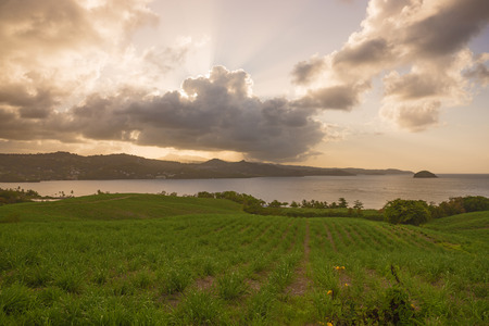 Sunset with dark clouds over the mountainsの写真素材