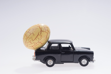 Big yellow easter egg on the black carの写真素材